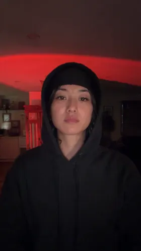 Woman · 480p: Hood up, cold stare
